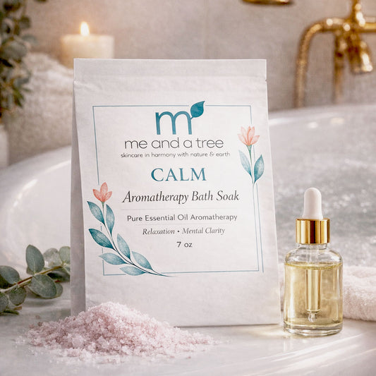 Aromatherapy bath soak packaging with a dropper bottle on a bathroom counter.