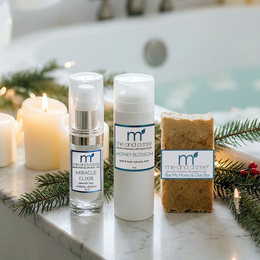 Cosmetic products on a bathtub ledge with candles and greenery