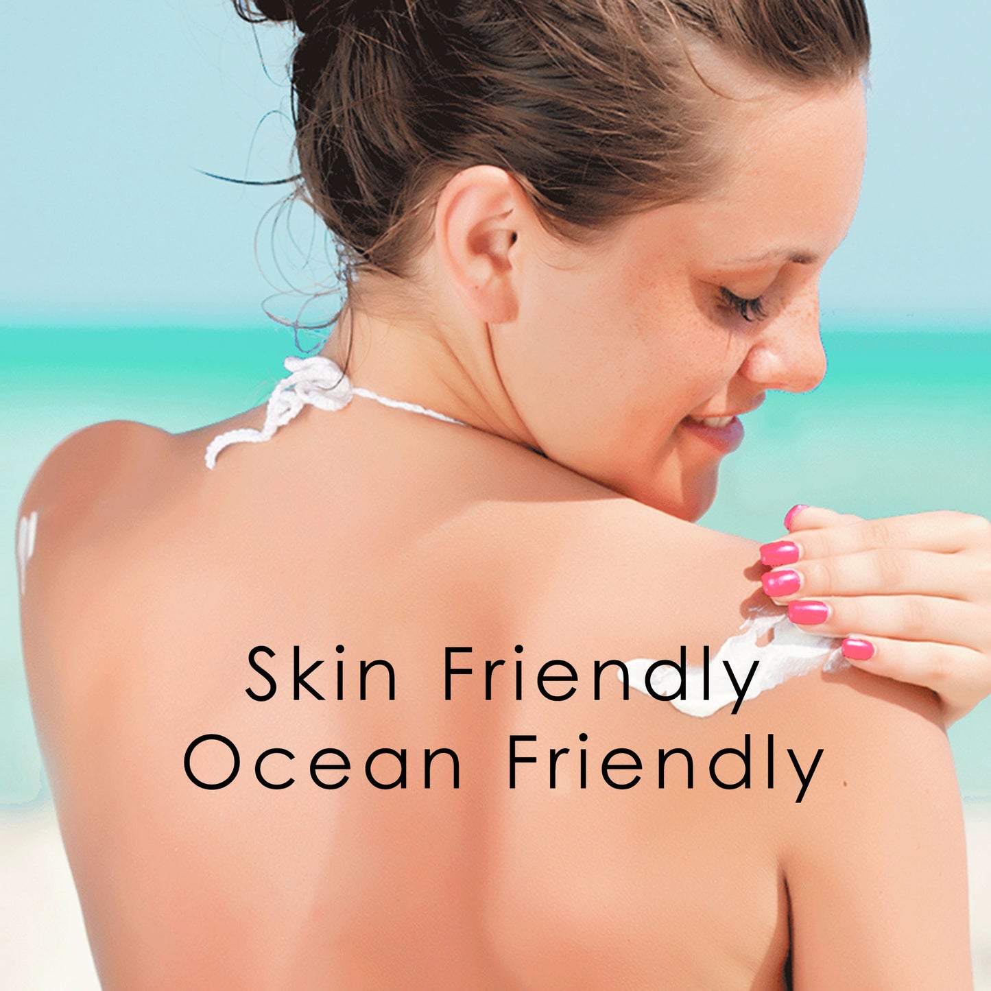 Happy woman applying natural reef safe sunscreen on face and smiling